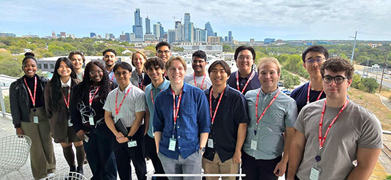 A group of EDGE Scholars pose in front of the Austin skyline.
