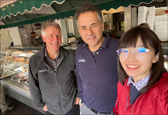 Tom Brown, Miguel Alonso, and Sherry Feng pose for a selfie at a bakery.