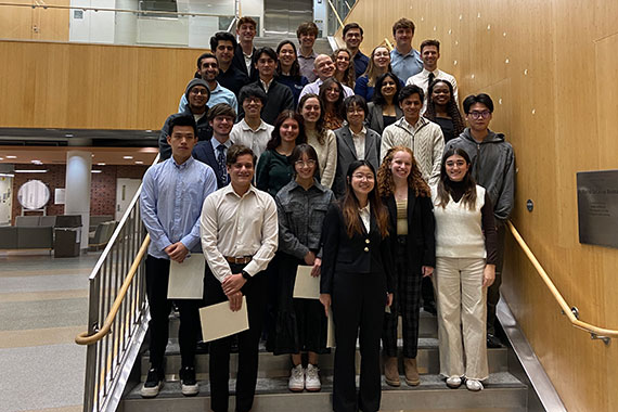 The newest members of Tau Beta Pi Engineering Honor Society pose on the stairs of the Goergen Hall atrium.