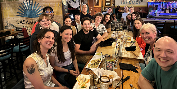 Chemical engineering students and faculty gathered around a table at a restaurant."