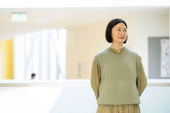 Zhen Bai with her arms behind her back and looking off camera.