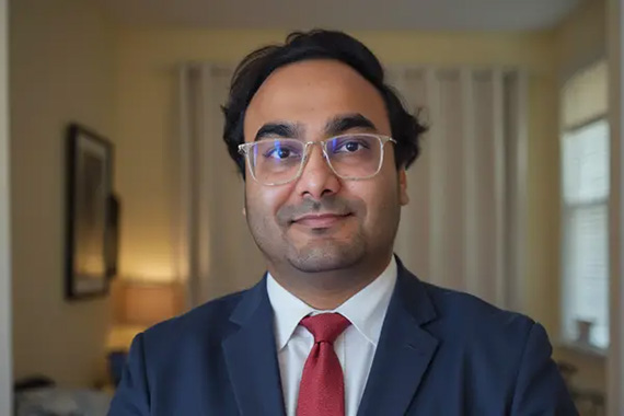 A closeup shot of Ananya Pareek wearing a suit and tie.