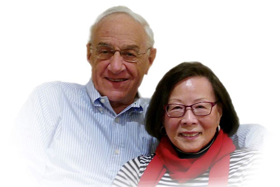 A medium closeup of Joe and Honmai Goodman with a feathered white background.