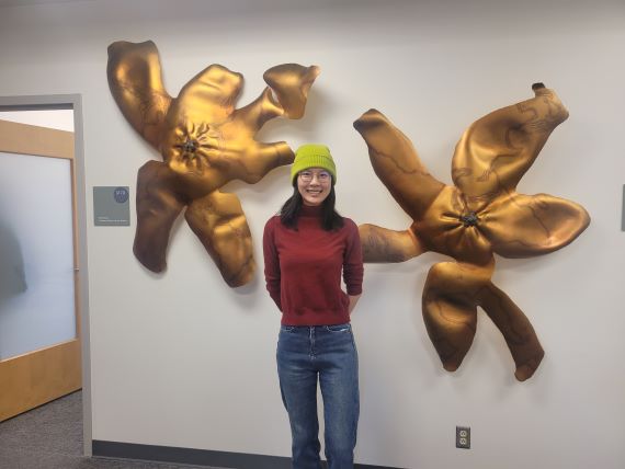 Artist and doctoral student Renee Jin with her works, “Mandarin Blossom of the South I and II," The art is made of stainless steel, spray chrome, paper-mache, hand coloring, and bronze.