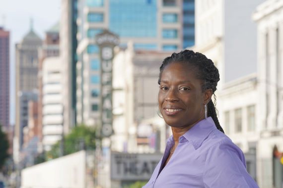 Photo of Sheila Rayam with the Buffalo Theatre District in the background.