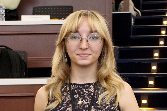 A closeup of biomedical engineering Alexa Trzpis accepting first place at the Forbes Business Pitch Competition.
