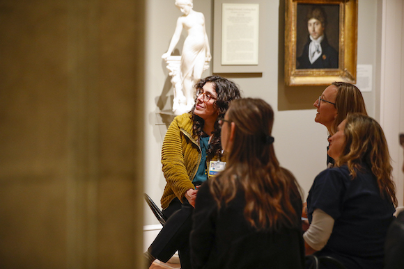 A group of clinicians takes in art in a museum. 