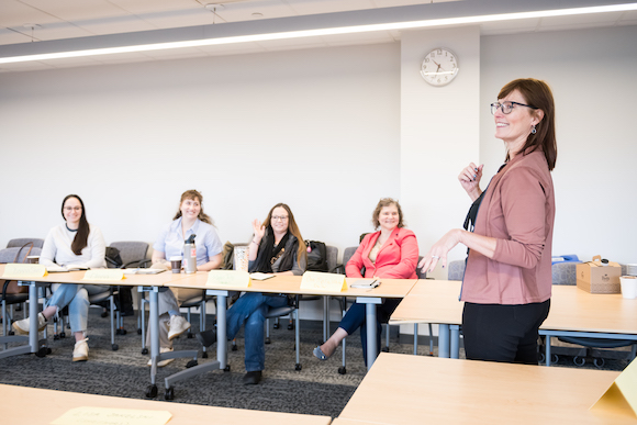 Instructor leads faculty in a meditation session. 