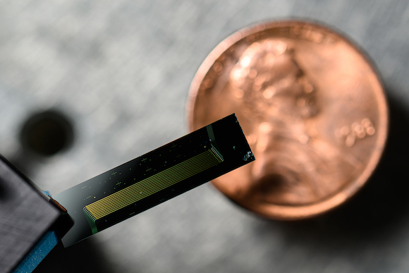 Chip-scale laser device with penny for scale.