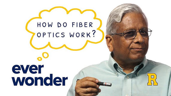 Govind Agrawal points a laser pen and an illustration of a thought bubble says "Ever wonder how do fiber optics work?"