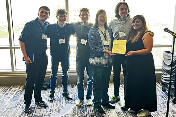 Students present Laurel Carney with a the David T Blackstock Mentorship Award.