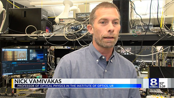 A screen capture of a WROC-TV interview with Professor Nick Vamivakas in his optics laboratory.