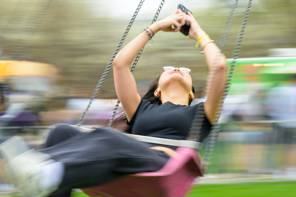 Student enjoys a ride on the swings during Dandelion Day. 