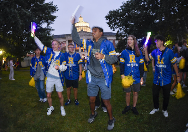 Students of the University of Rochester class of 2029 attend a jersey giveaway and Candlelight Ceremony after signing the class roll on Eastman Quad.
