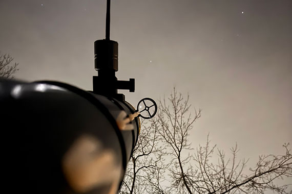 A view from behind a Cassi telescope pointed at the stars at night.