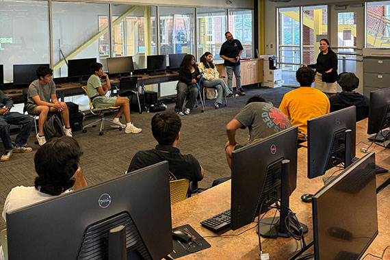 Wendi Heinzelman speaks to a class of about a dozen students in a computer lab in Rettner Hall.