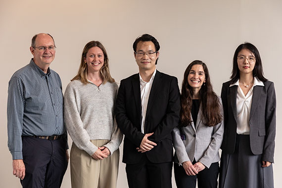Five new faculty members from the Hajim School stand next to one another in front of a light gray backdrop.