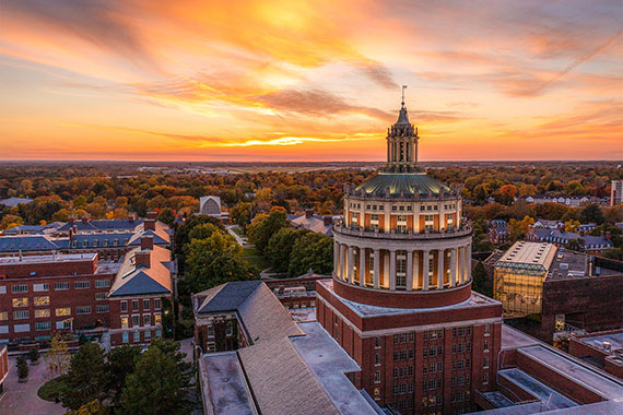 An aerial shot of the Rush Rhees tower during a sunset.