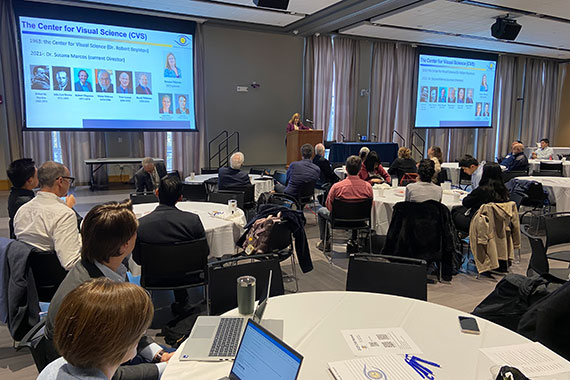 Dozens of people sit at tables in the Feldman Ballroom.