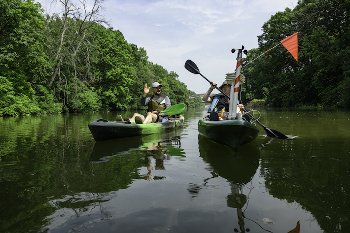 researchers in kayaks gather samples at the convergence of the Erie Canal and Genesee River.