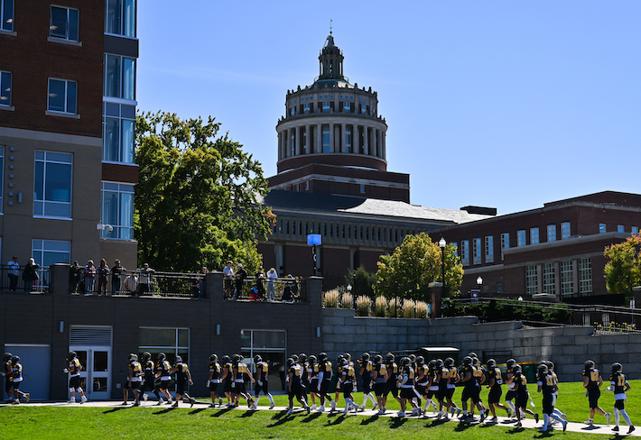 football players takes the field. 