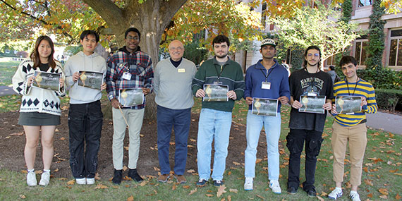 Winners of the Heist Hackathon pose with their certificates on the Eastman Quad.