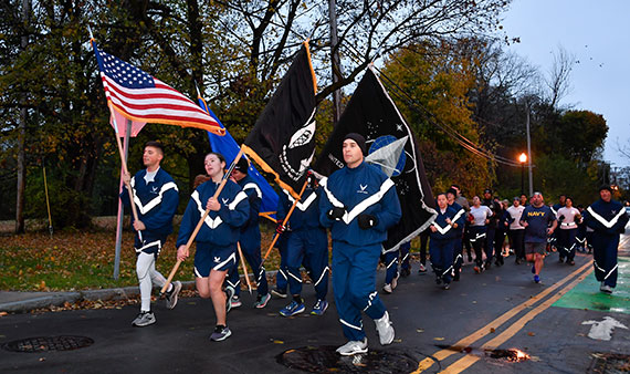 A group of runners participate in the Veterans Day 5K on the University of Rochester's River Campus.