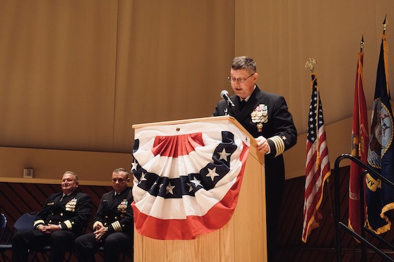 Captain Nathan York speaks at a lecturn.