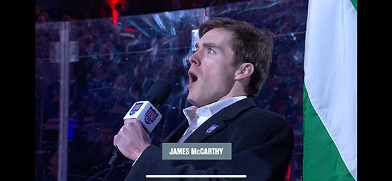James McCarthy sings into a microphone.