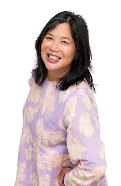 Headshot of woman smiling, wearing a purple flowered dress.