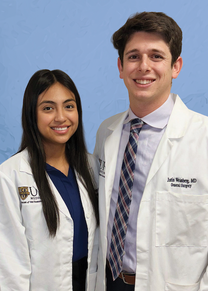 Headshot of female doctor and male doctor in white coats. 