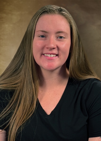 Headshot of University employee with long blonde hair wearing a black top. 