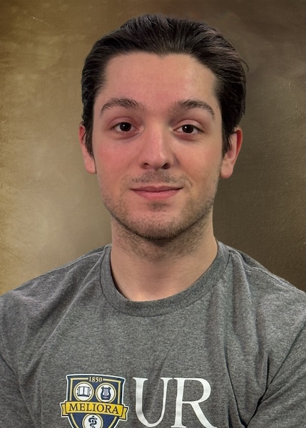 Headshot of a man with short brown hair wearing a UR T-shirt.