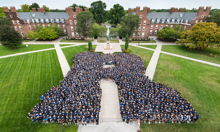 Large letter R formed by University of Rochester students. 