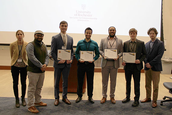 Students who won awards at the Charles and Janet Forbes Entrepreneurial Competition pose with their certificates.