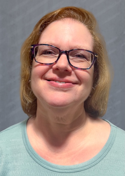 Smiling woman in a green shirt. 