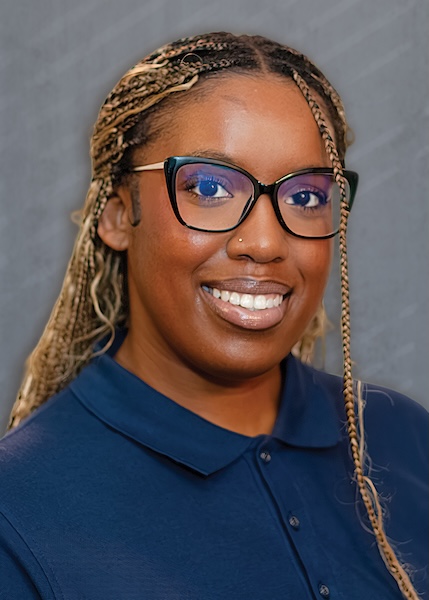 Smiling woman in glasses and a blue shirt. 