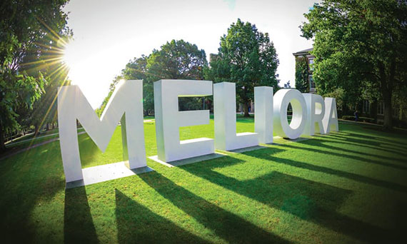 Large letters spelling "Meliora" on the Eastman Quad.