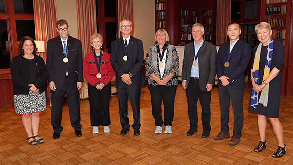 Institute of Optics faculty recently appointed to endowed professorships pose with donors and administrators at an installation event.