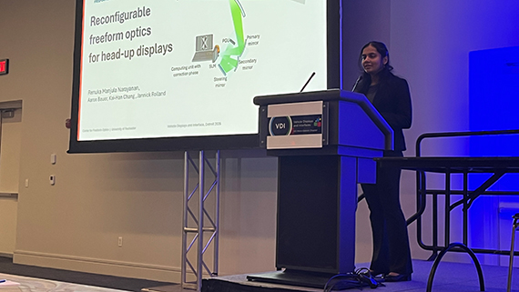 Renuka Manjula Narayanan speaks at a podium while presenting her research paper.