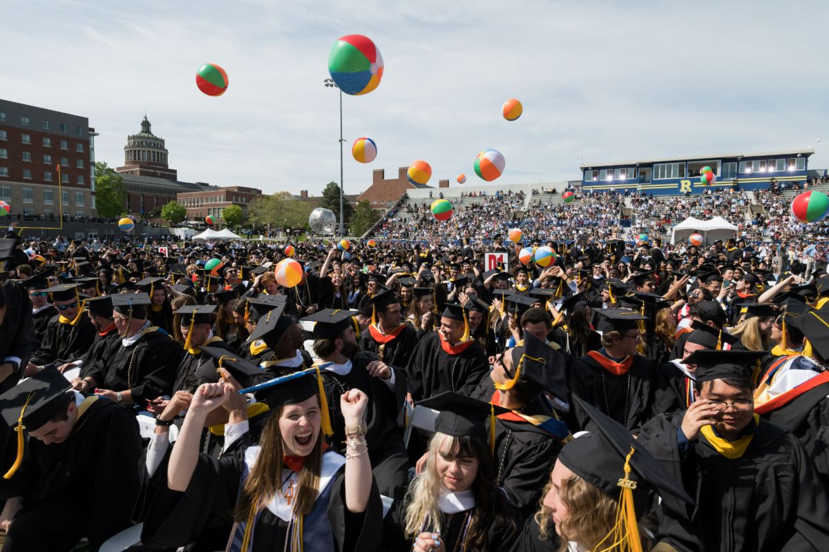 A large group of University of Rochester graduates proudly wearing gowns and caps during their commencement ceremony.