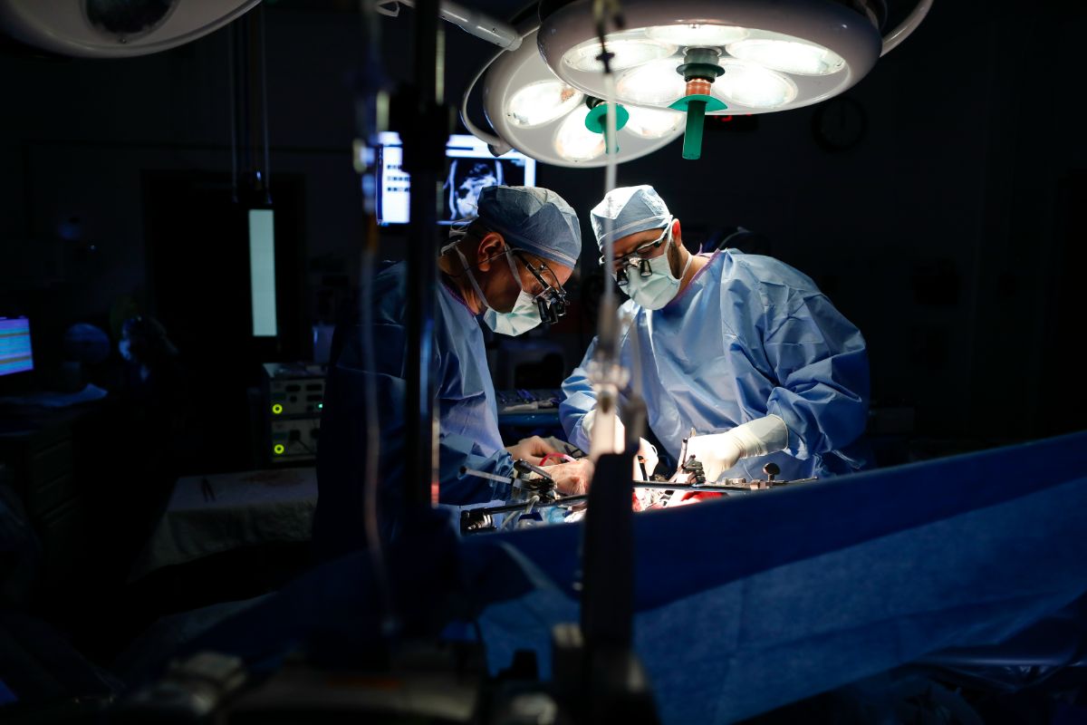 Two surgeons perform surgery on a patient in an operating room at the University of Rochester Medical Center.
