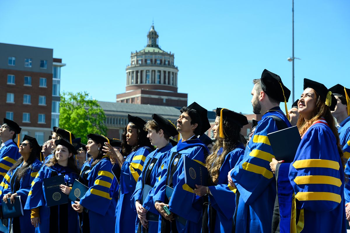 University of Rochester graduates gathered near Rush Rhees Library during Commencement.
