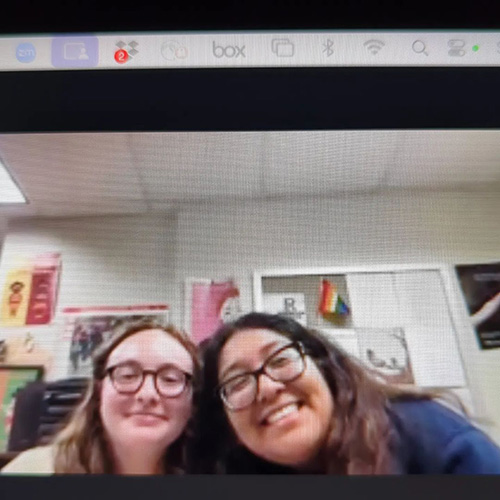 Two students smiling on a Zoom screen.