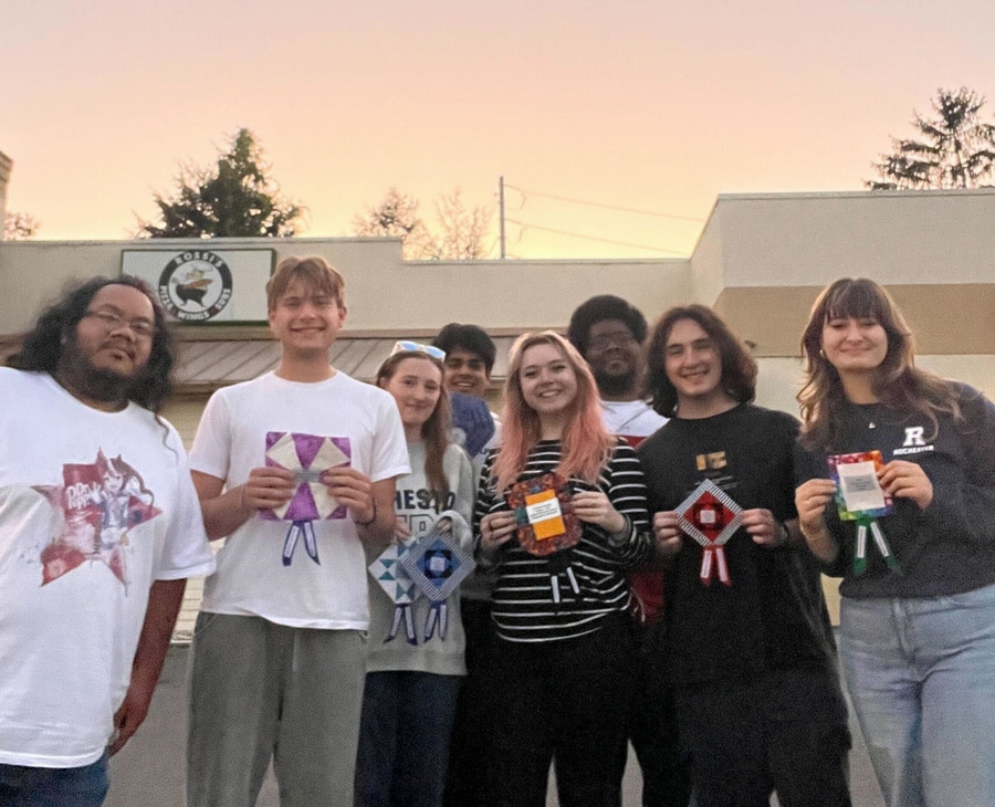 A group of people smiling at the camera as they pose for a photo.