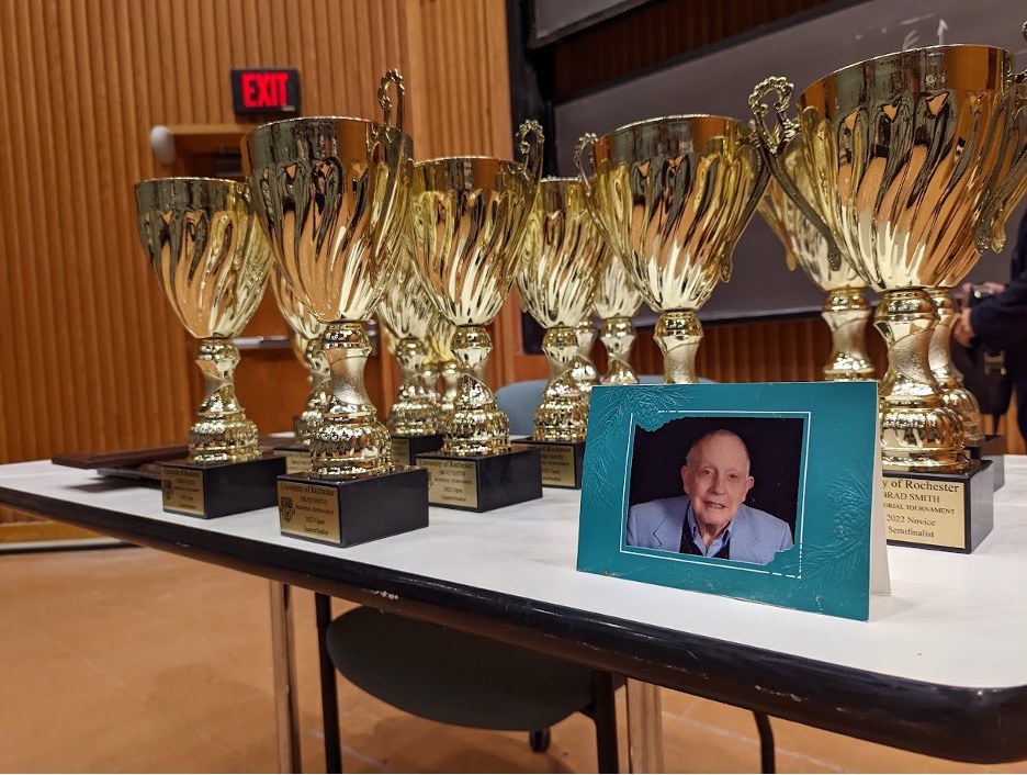 A table with trophies and a photo of Brad Smith.