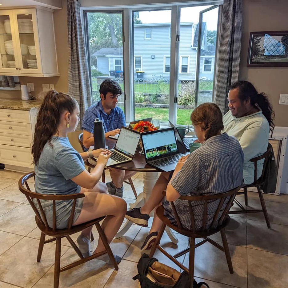 Four people sitting around a table.