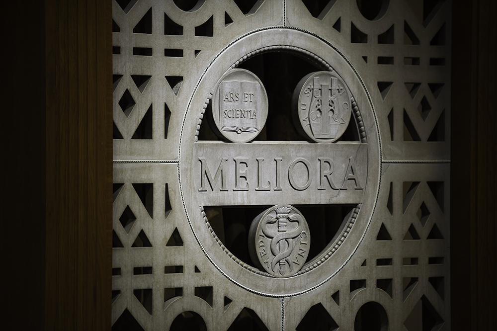 A wall detail with the word Meliora.