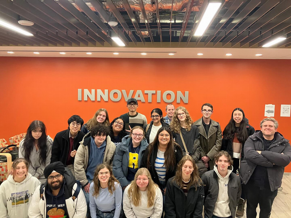 A group of people smiling at the camera as they pose for a photo.