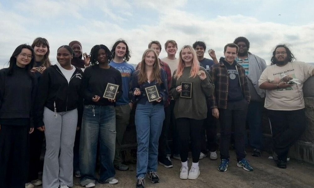 A group of people smiling at the camera as they pose for a photo.